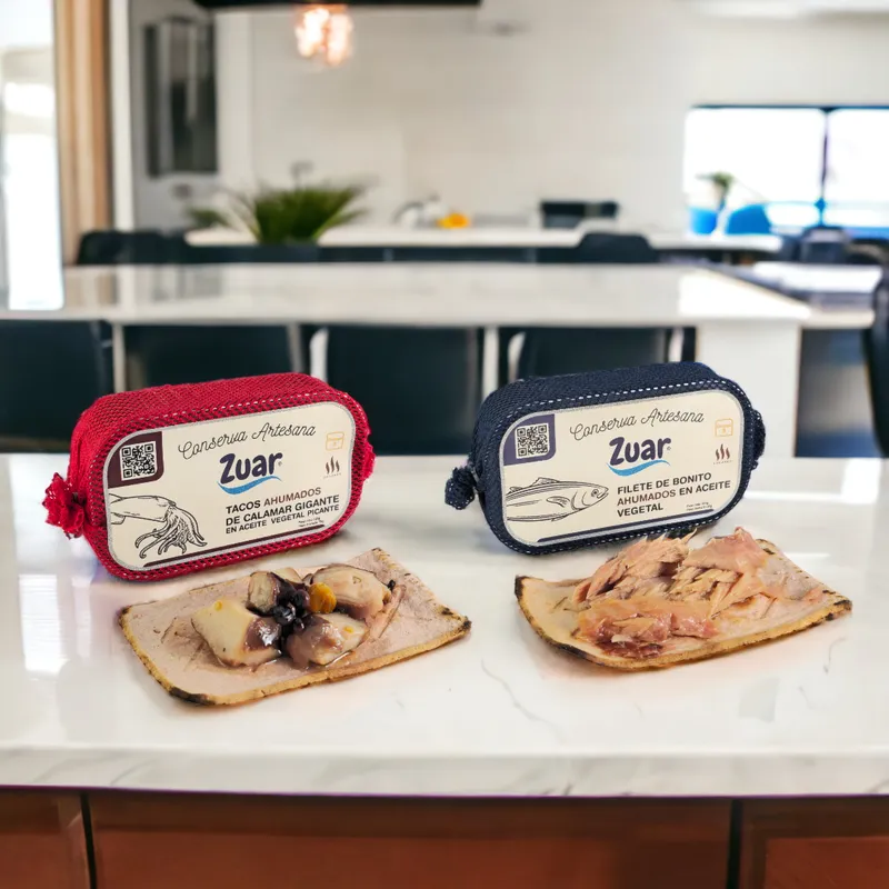 ZUAR artisan canned giant squid chunks and smoked bonito fillet on a kitchen table.